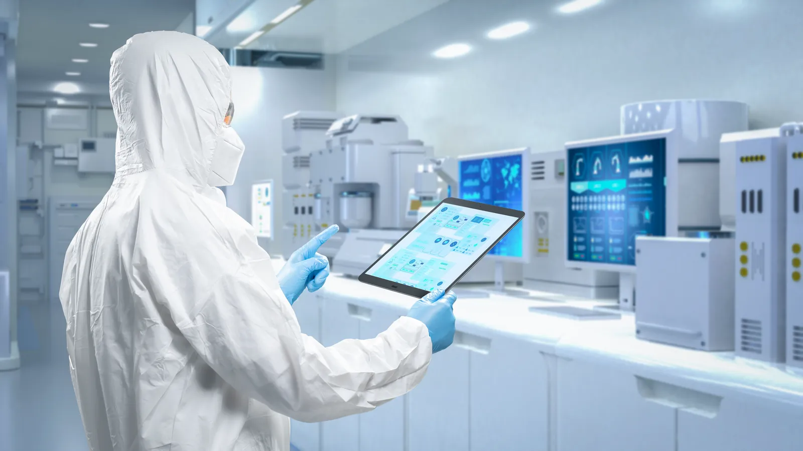 Operator in protective coverall working in a semiconductor manufacturing facility